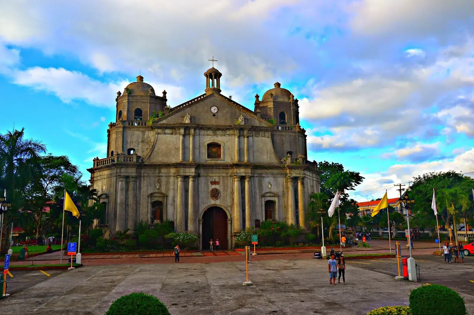 A historic stone church and plaza in a Bicol town
